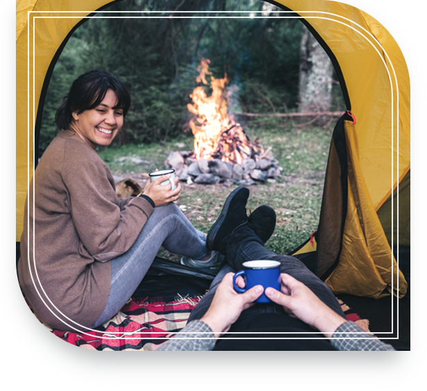 Couple relaxing in front of a campfire knowing that their wills and trusts are in order.