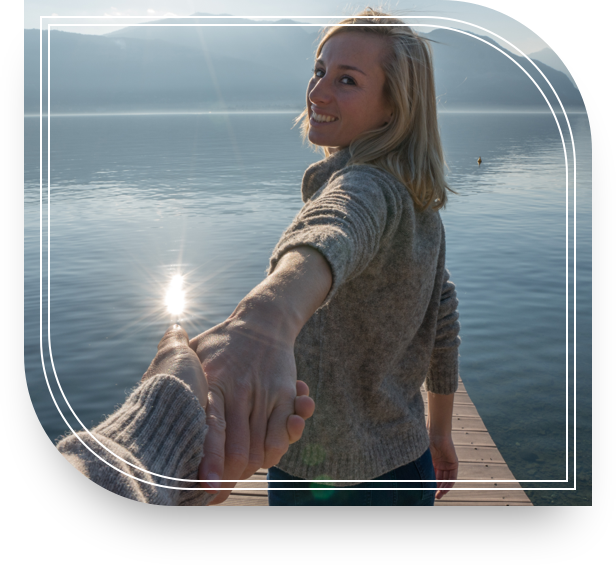 Woman on a dock looking back and holding hands, relaxed because she has Private Bank deposit solutions.