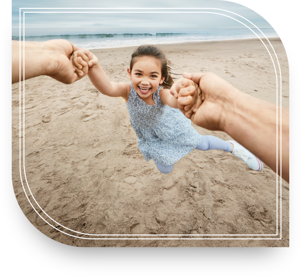 A father’s hands are swinging his daughter as they spend a carefree afternoon at the beach because of private banking.