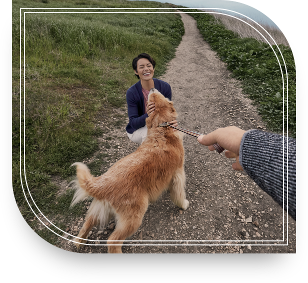 Woman plays with her dog outside after a wealth planning meeting.