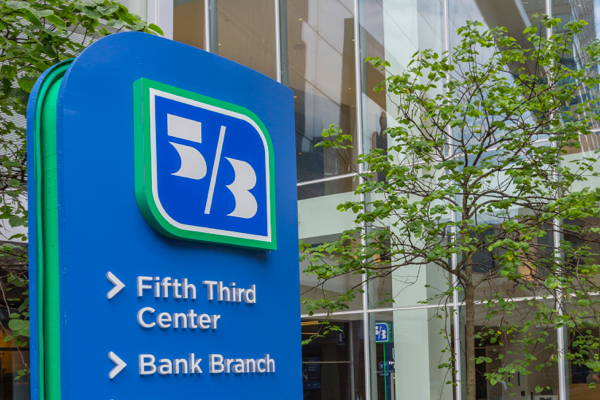 Fifth Third Center signage welcoming employees and customers with blue sky and trees