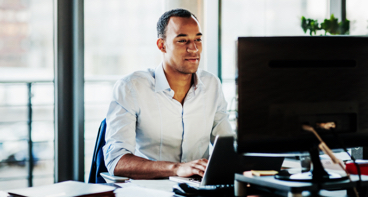 Man on a computer looking up custody services online.