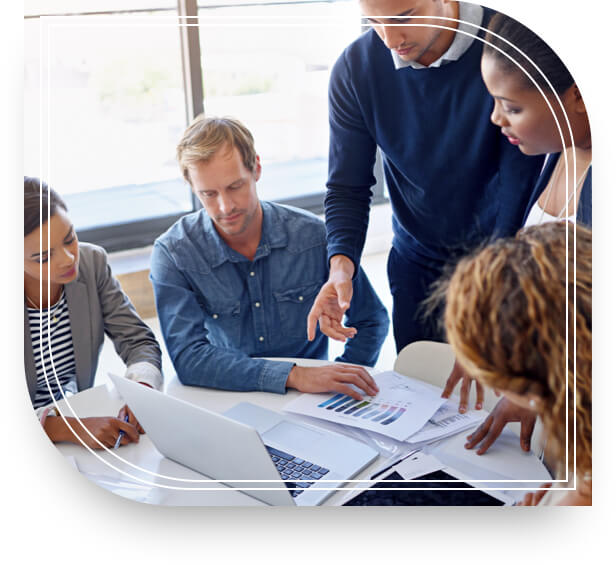 A meeting of the investment management services team around a table in a conference room.