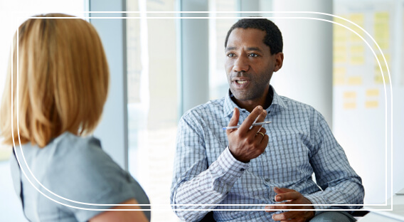 Man and woman in business meeting discussing individual insurance. 