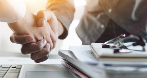 Retirement advisor shaking the hand of a new client. 