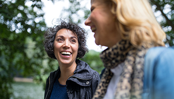 Two woman walking down and enjoying a laugh together