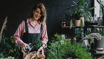 A woman, tending to her plants.