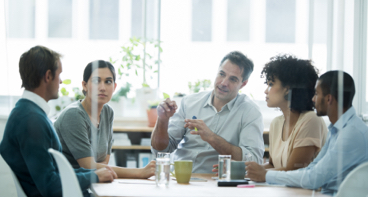 Institutional investors in a conference room talking about investment strategies.