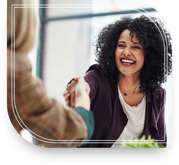 A woman shakes hands with another woman after securing a Private Bank loan. 