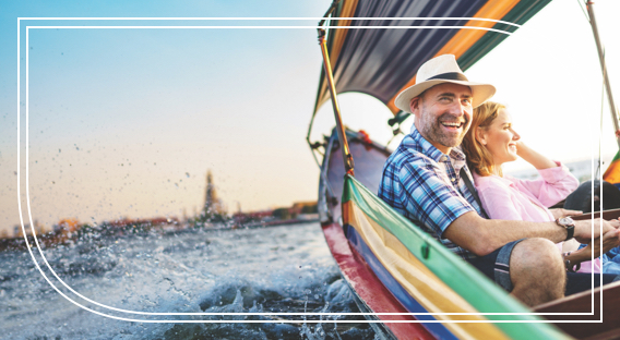 A man and woman riding on a boat and smiling