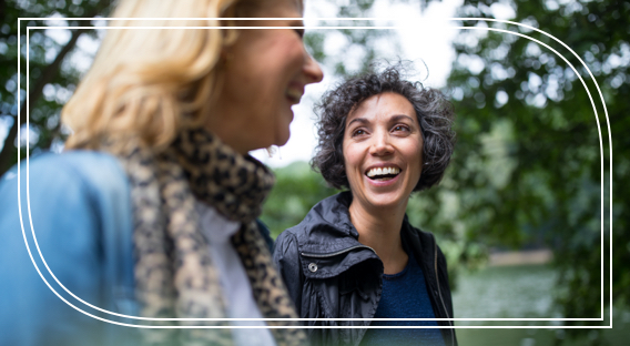 Two women laughing outdoors