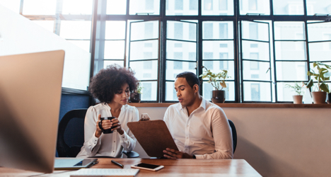 Man and woman reviewing options for fiduciary investment services