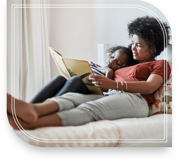 Mother reading a book to her daughter who will receive her assets when she is of age.