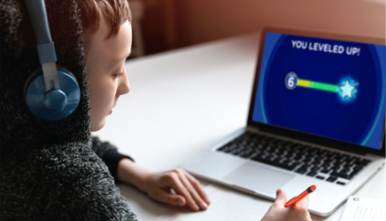 A student works through a Young Bankers Club lesson on his laptop